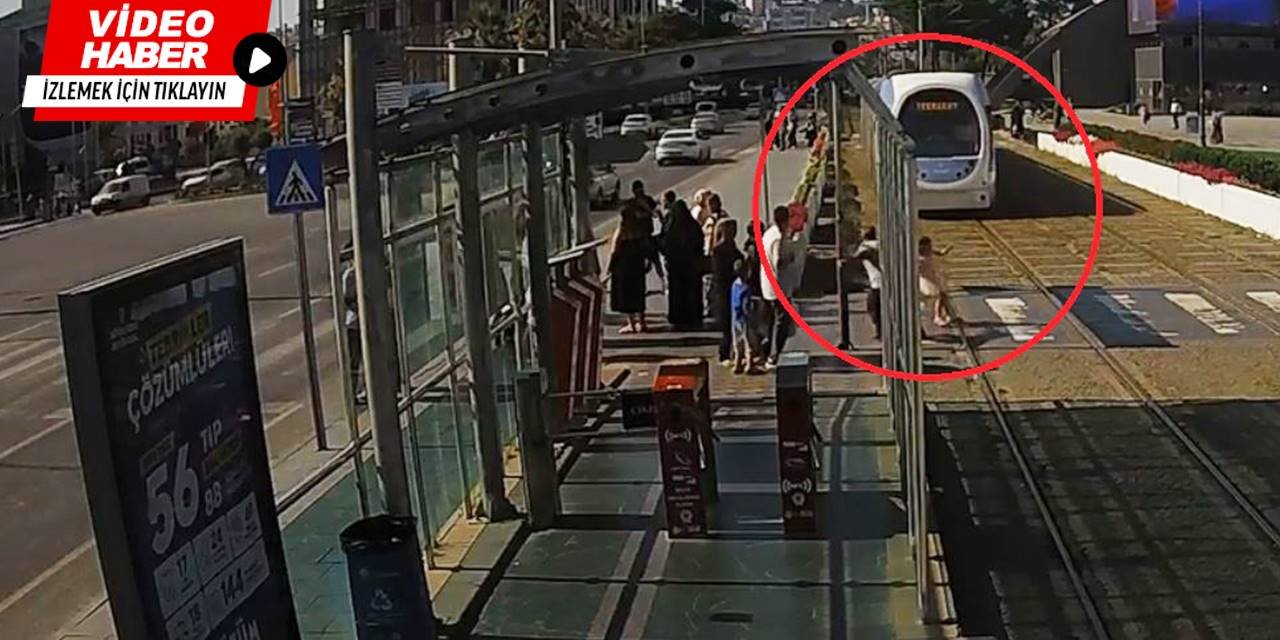Raylara atlayan küçük kızı tişörtünden çekerek kurtardı
